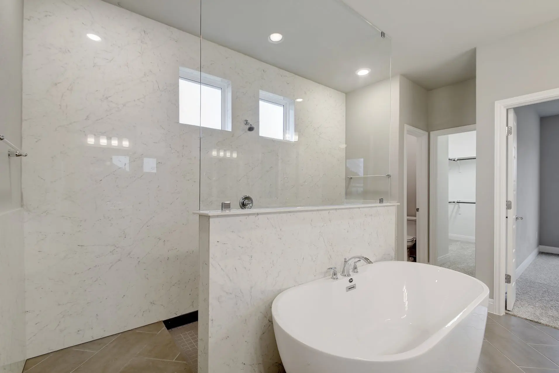 A white bathroom with a tub and shower.